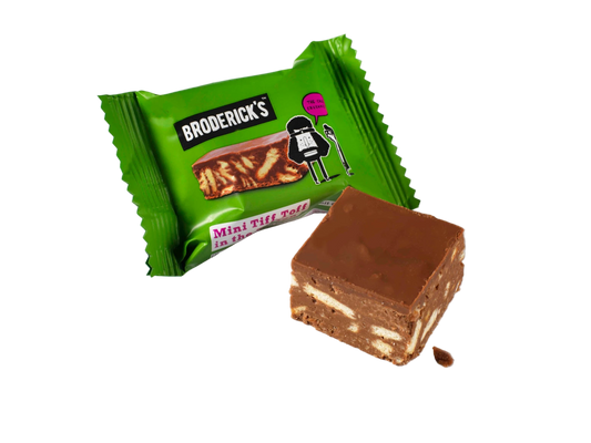 A pouch of Tiffin biscuit mini bites with one bite-sized piece of chocolate with crunchy biscuit pieces visible outside the pouch.